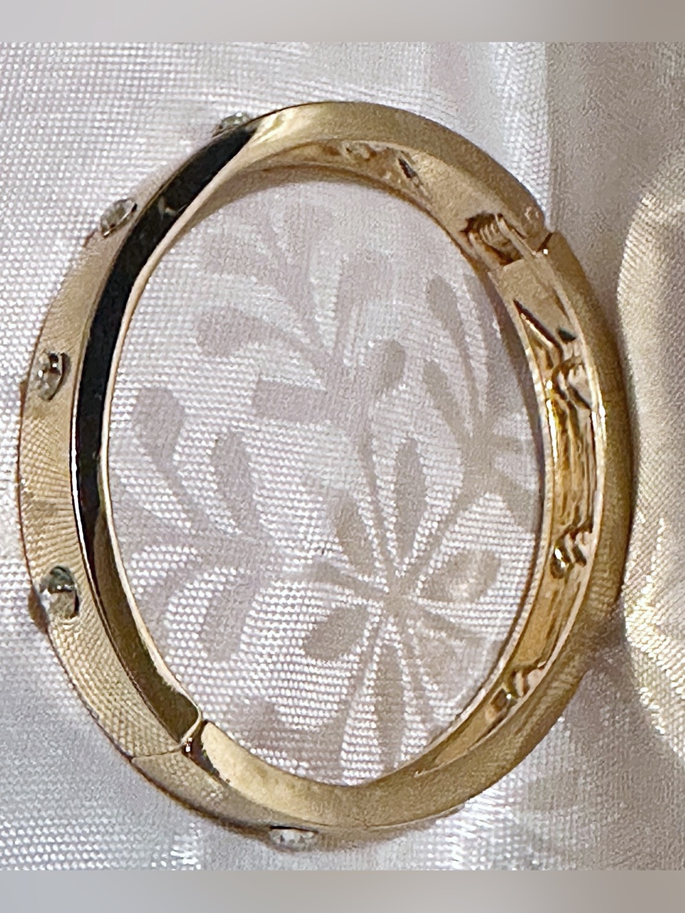 Gold Tone Hinged Bangle Bracelet with Stud Accents